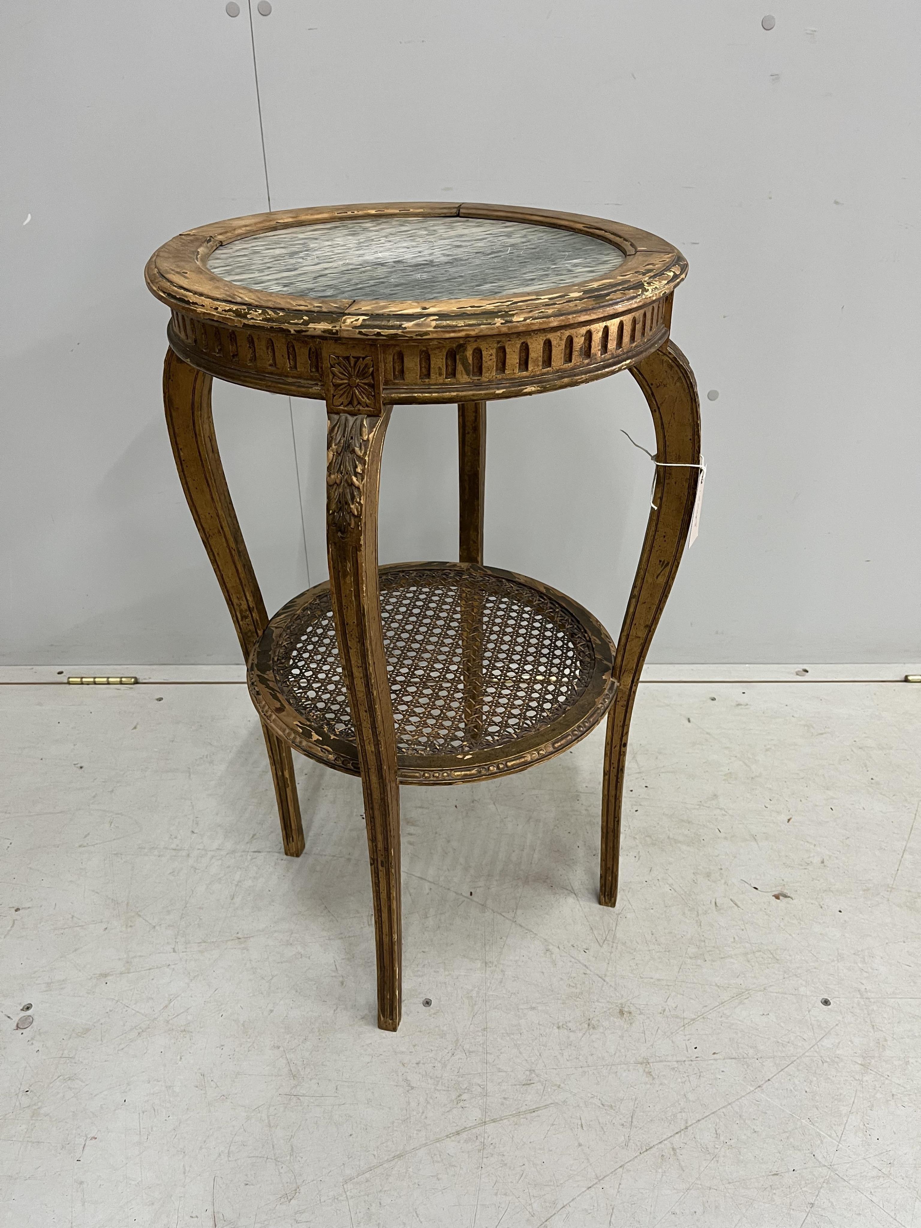 A late 19th century French circular marble topped giltwood two tier table with caned undertier, diameter 46cm, height 75cm. Condition - poor to fair